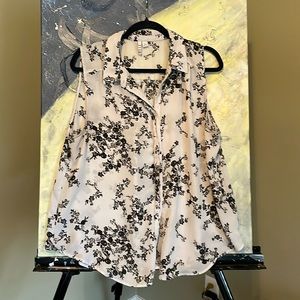 White sheer sleeveless top with black flower clusters